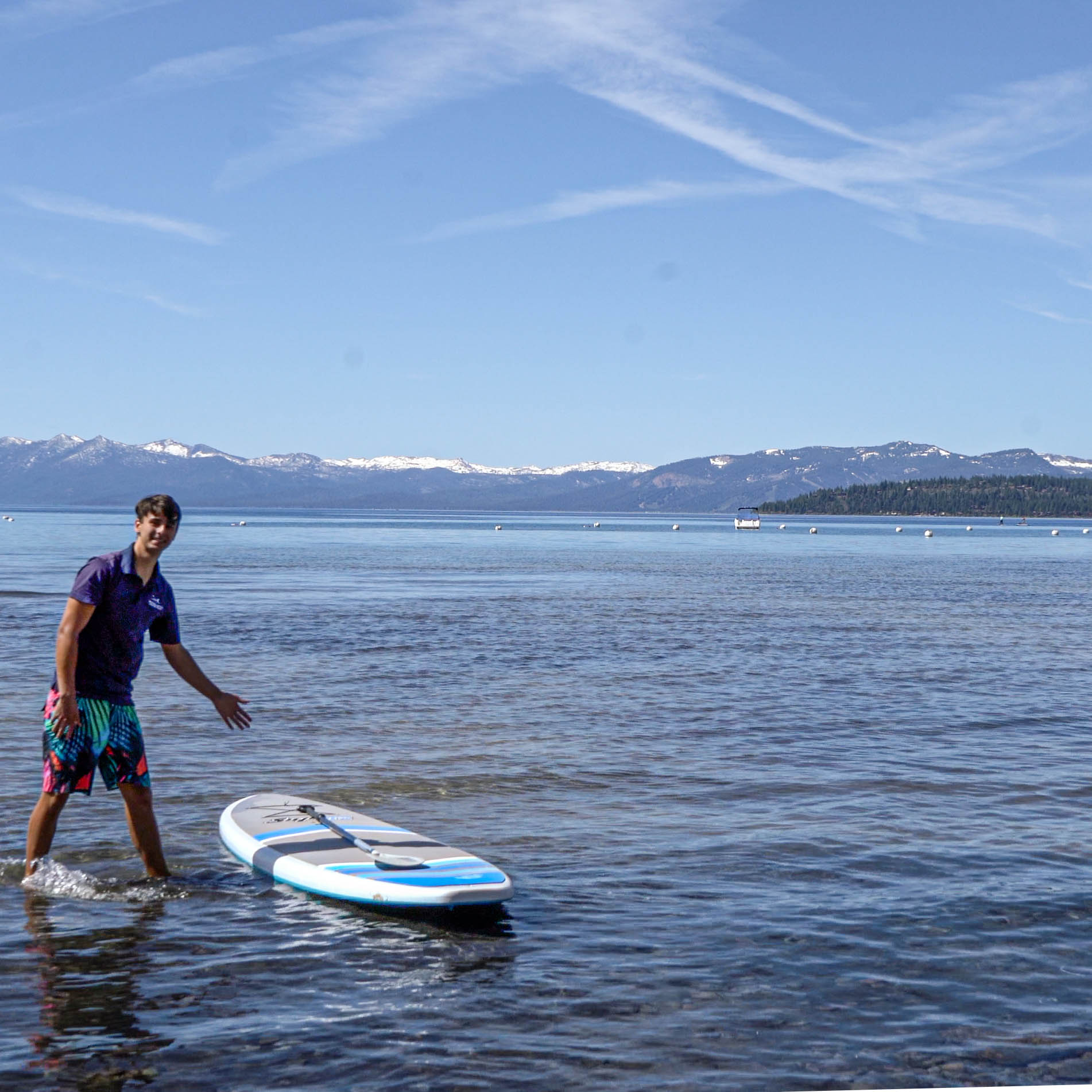 Guest with Stand Up Paddleboard on Lake Tahoe Beach